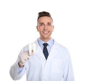 Photo of Male dentist holding tooth model on white background