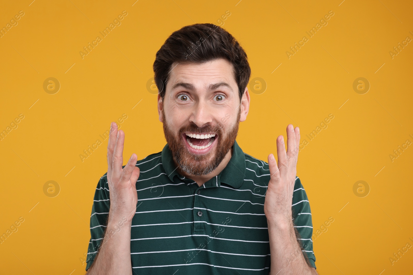 Photo of Portrait of surprised man on yellow background