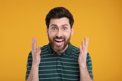 Photo of Portrait of surprised man on yellow background