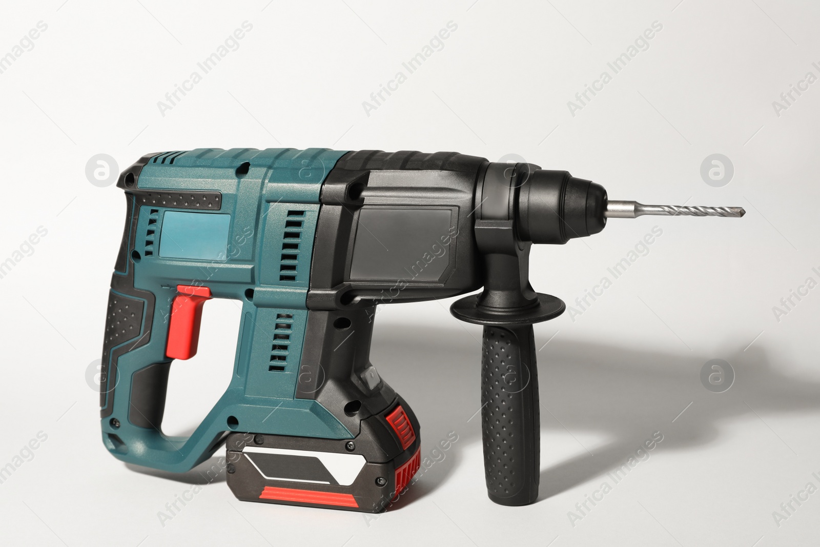 Photo of Modern electric power drill on light background