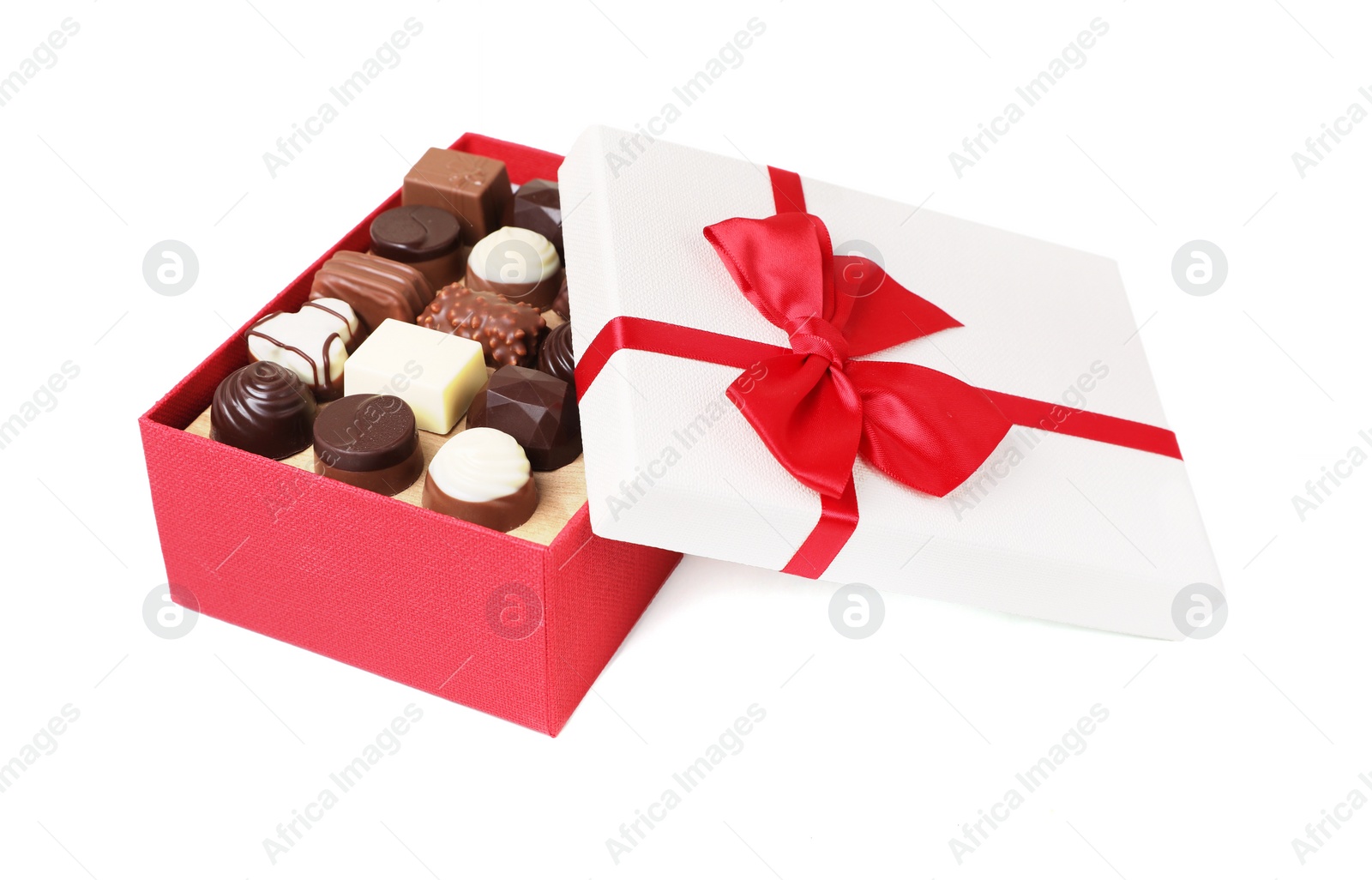 Photo of Red box with tasty chocolate candies isolated on white