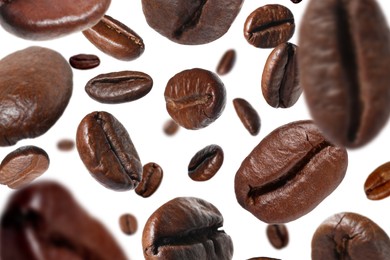 Roasted coffee beans falling o white background