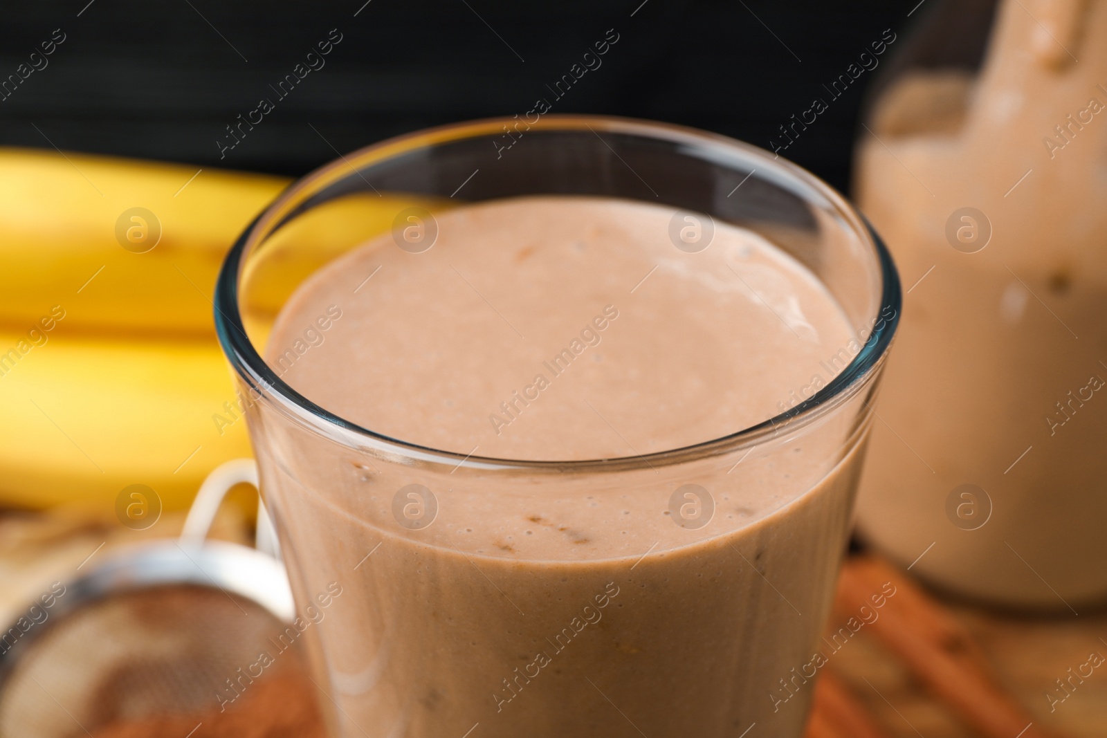 Photo of Glass of tasty banana smoothie, closeup view