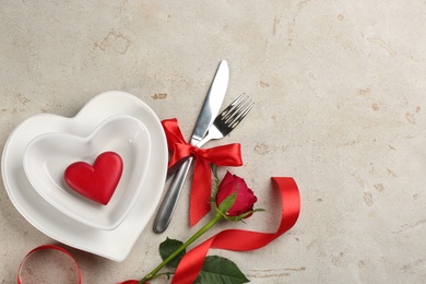 Photo of Beautiful table setting on light background, flat lay with space for text. Valentine's Day dinner