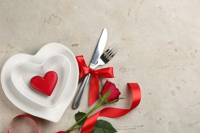 Beautiful table setting on light background, flat lay with space for text. Valentine's Day dinner