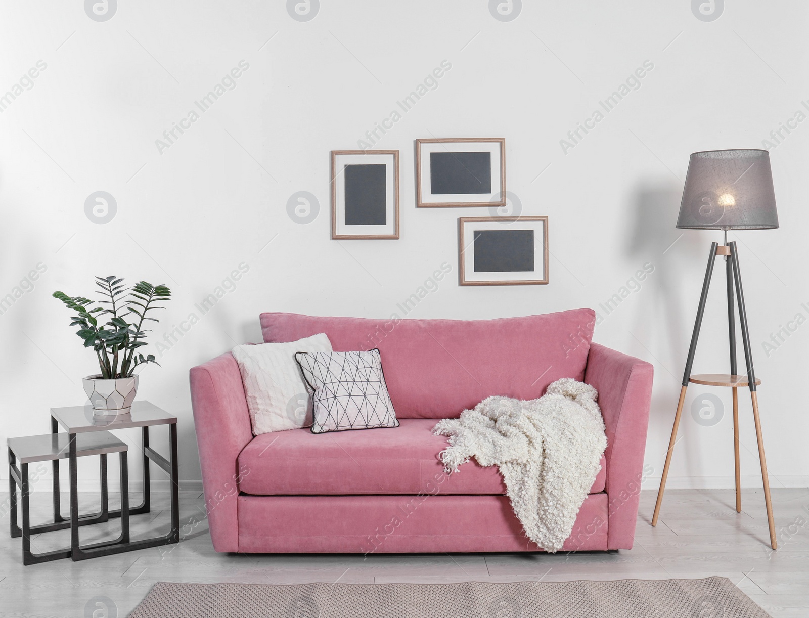 Photo of Comfortable sofa with pillows in modern living room interior