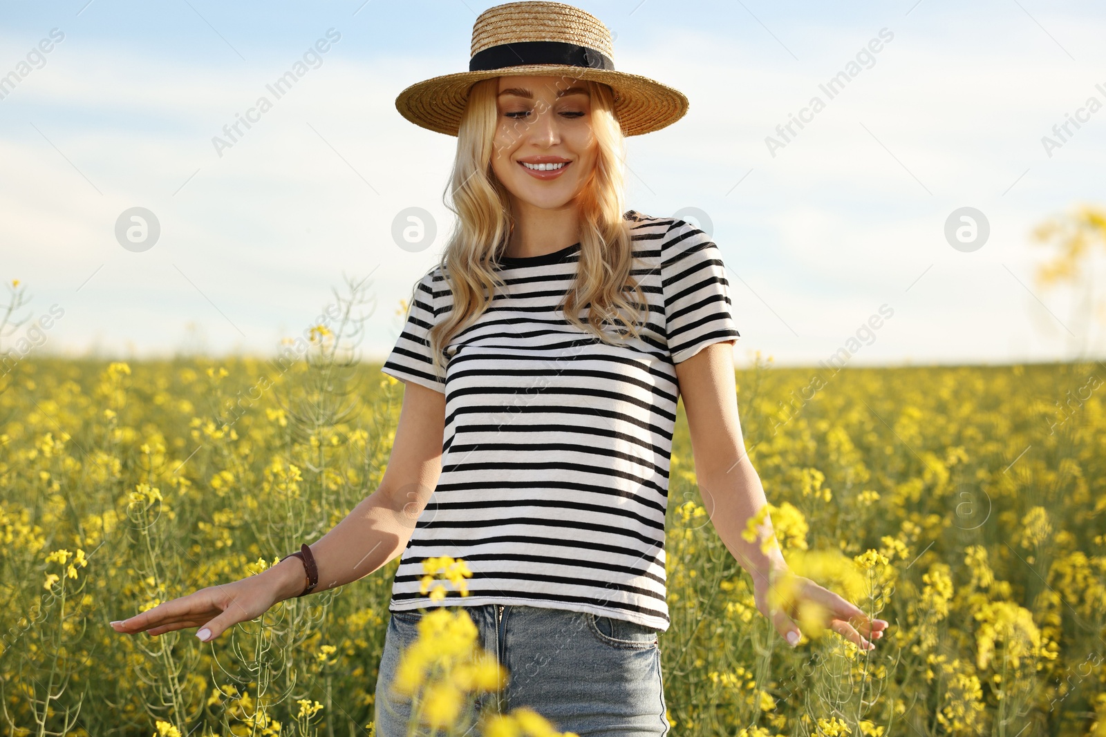 Photo of Happy young woman with straw hat in field on spring day