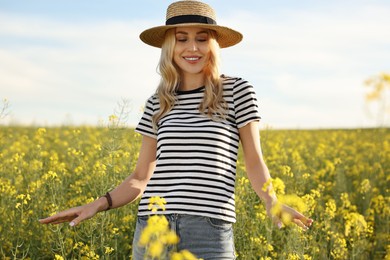 Photo of Happy young woman with straw hat in field on spring day