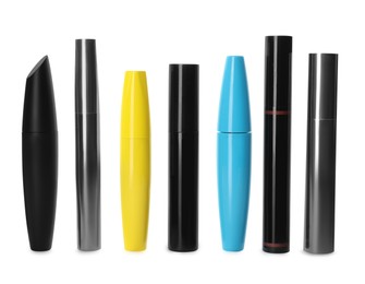 Photo of Many mascaras for eyelashes on white background. Makeup product