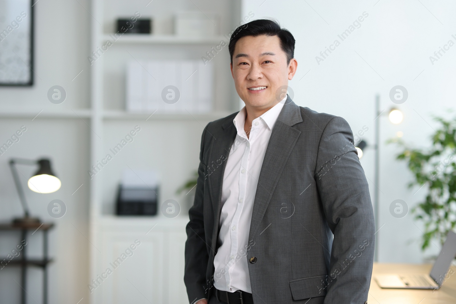 Photo of Portrait of smiling businessman in office. Space for text
