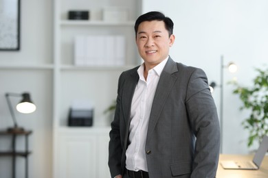 Portrait of smiling businessman in office. Space for text