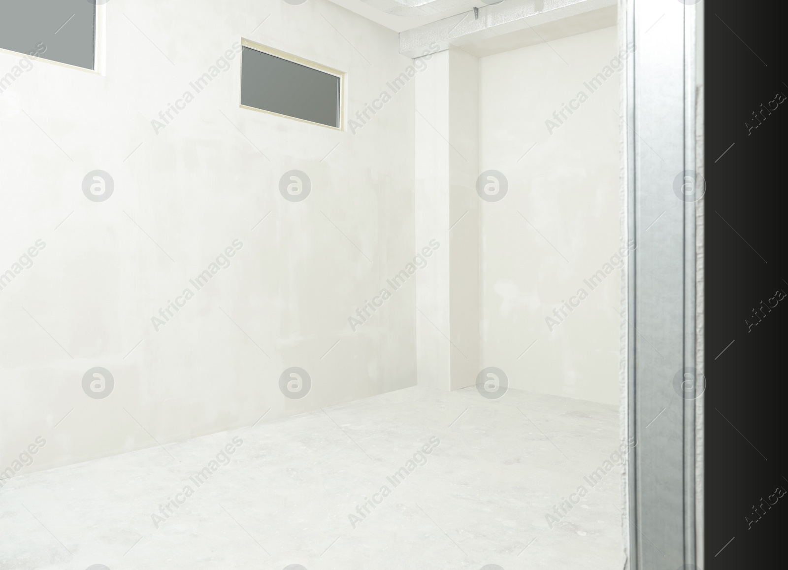 Photo of Empty room with white walls and windows