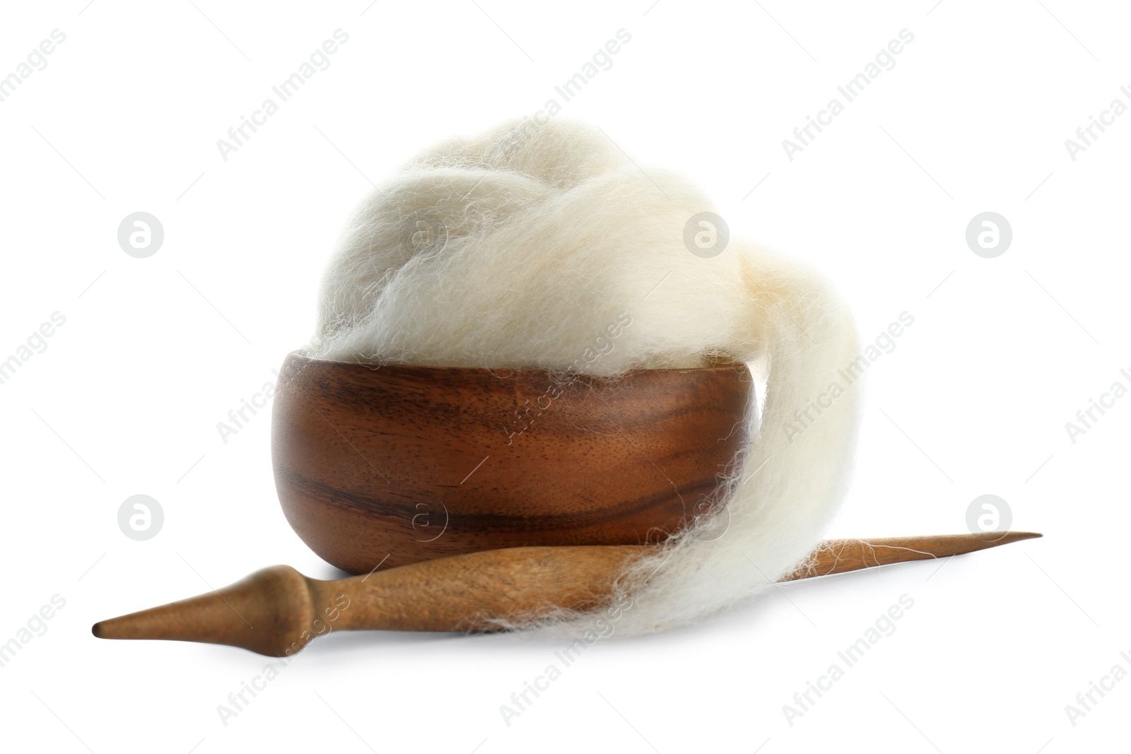 Photo of Ball of combed wool with wooden spindle and bowl isolated on white