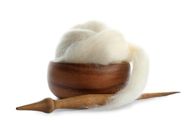 Ball of combed wool with wooden spindle and bowl isolated on white
