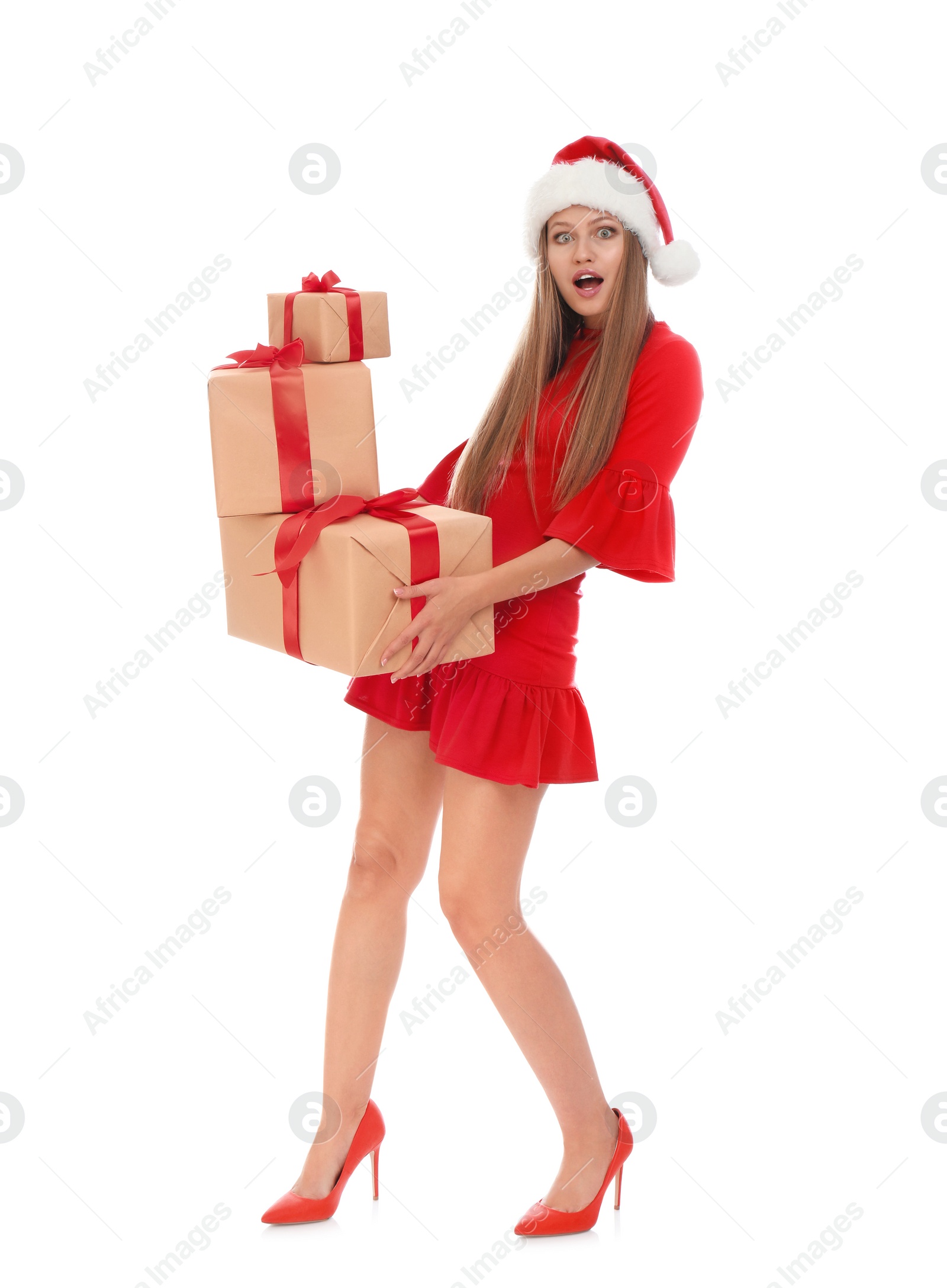 Photo of Emotional young woman in Santa hat with Christmas gifts on white background