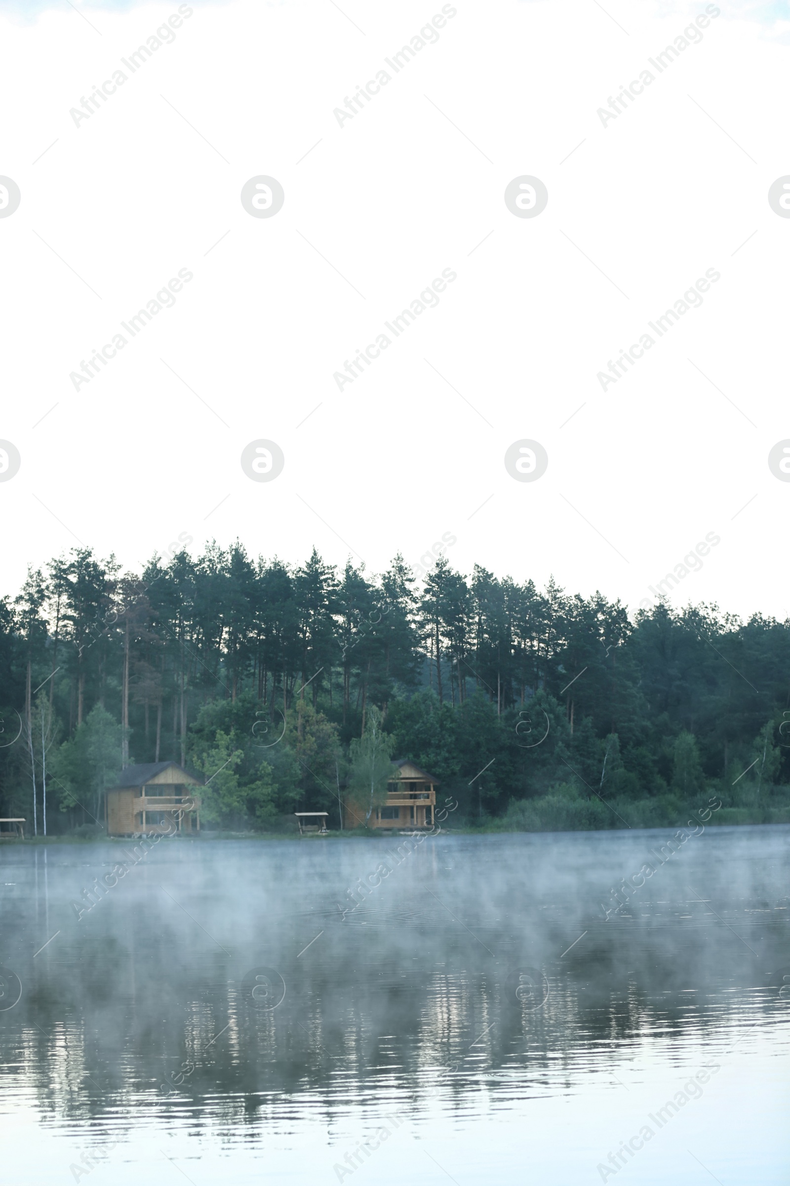 Photo of Beautiful landscape with forest and houses near lake. Camping season