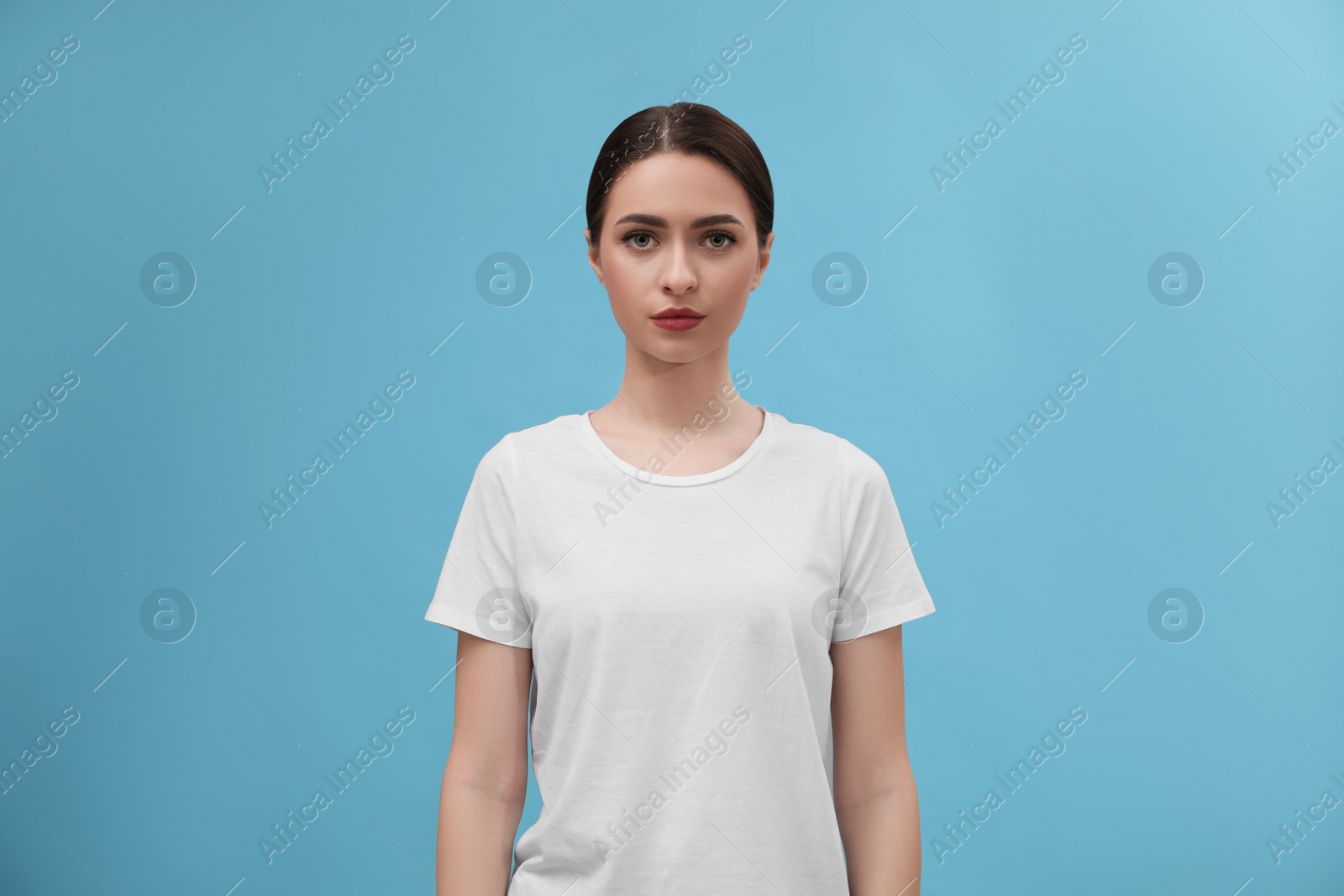 Photo of Portrait of beautiful woman on light blue background