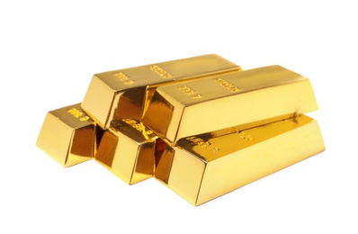 Photo of Precious shiny gold bars on white background