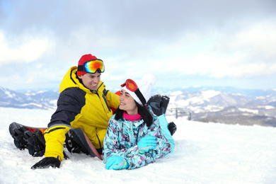 Lovely couple on snowy hill. Winter vacation