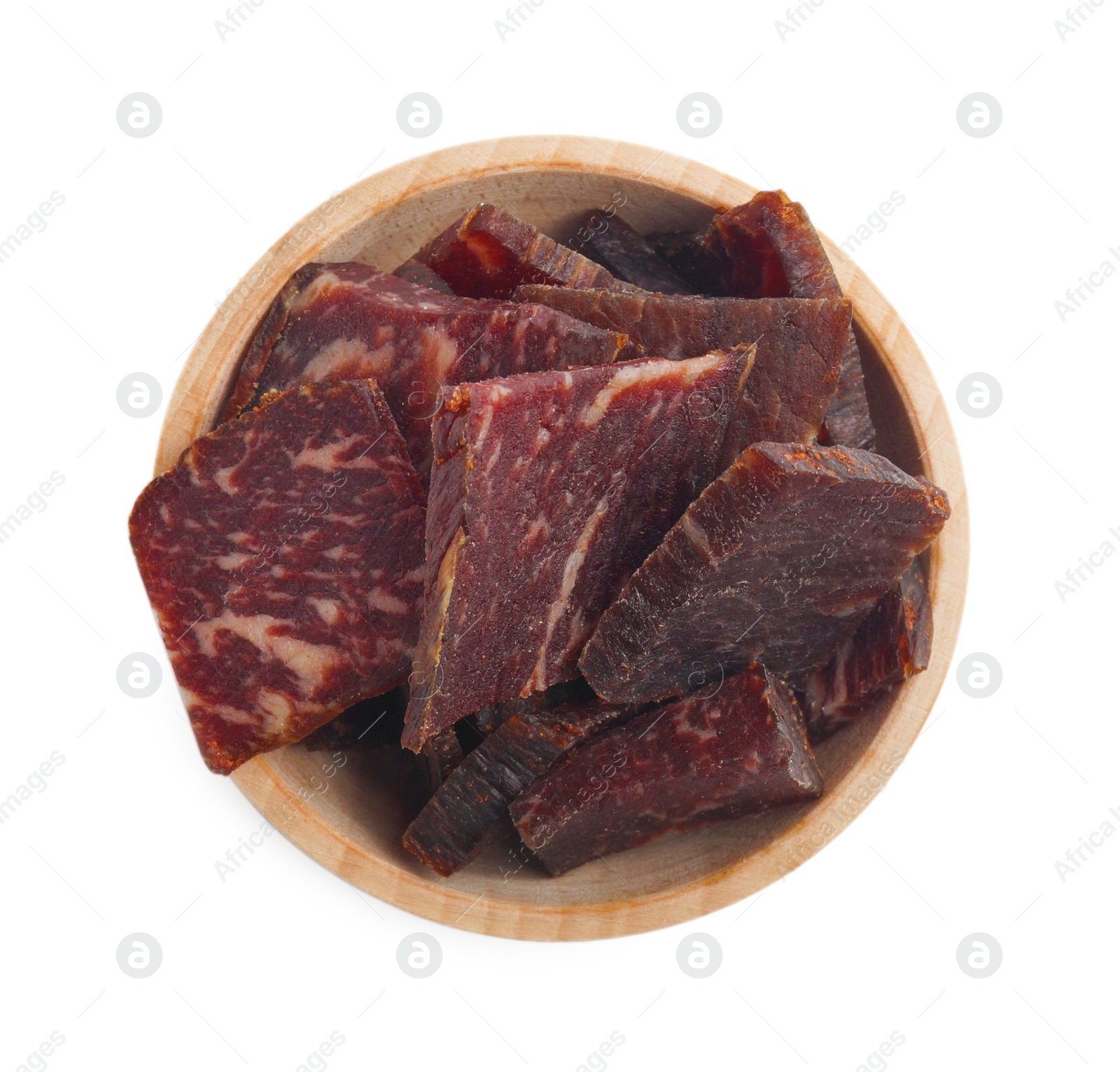 Photo of Delicious beef jerky in wooden bowl isolated on white, top view