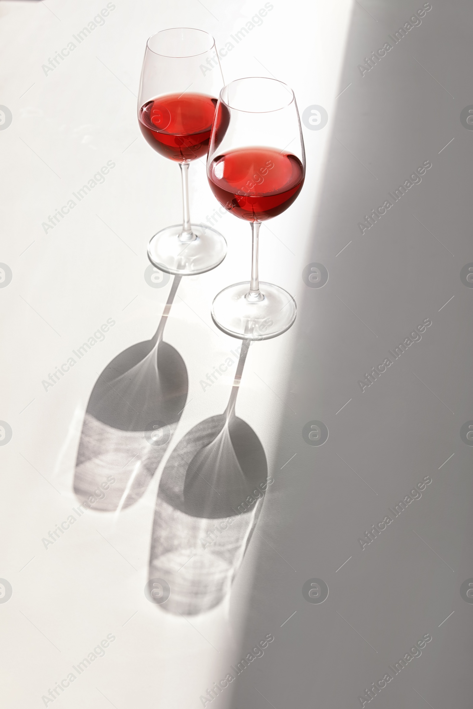 Photo of Glasses with delicious wine on table indoors