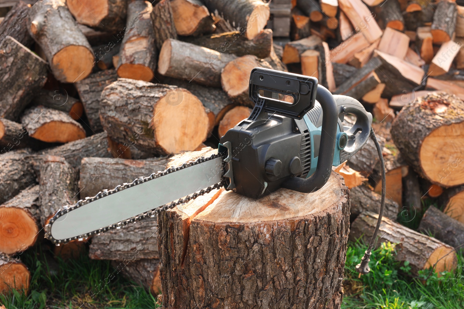 Photo of One modern saw on wooden log outdoors