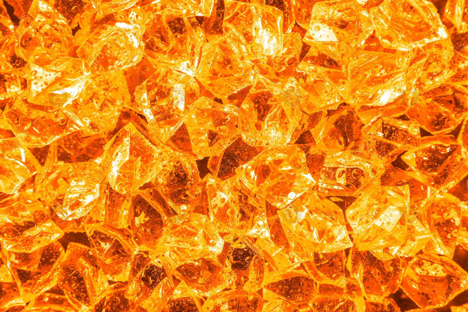 Image of Pile of crushed ice as background, top view. Toned in orange color