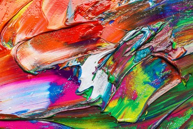 Strokes of colorful acrylic paints as background, closeup view