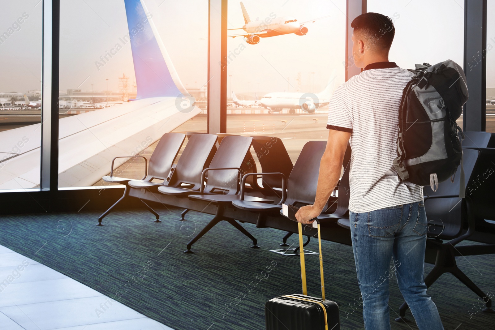 Image of Man with backpack and travel suitcase at airport terminal. Summer vacation