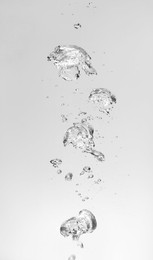 Air bubbles in water on white background