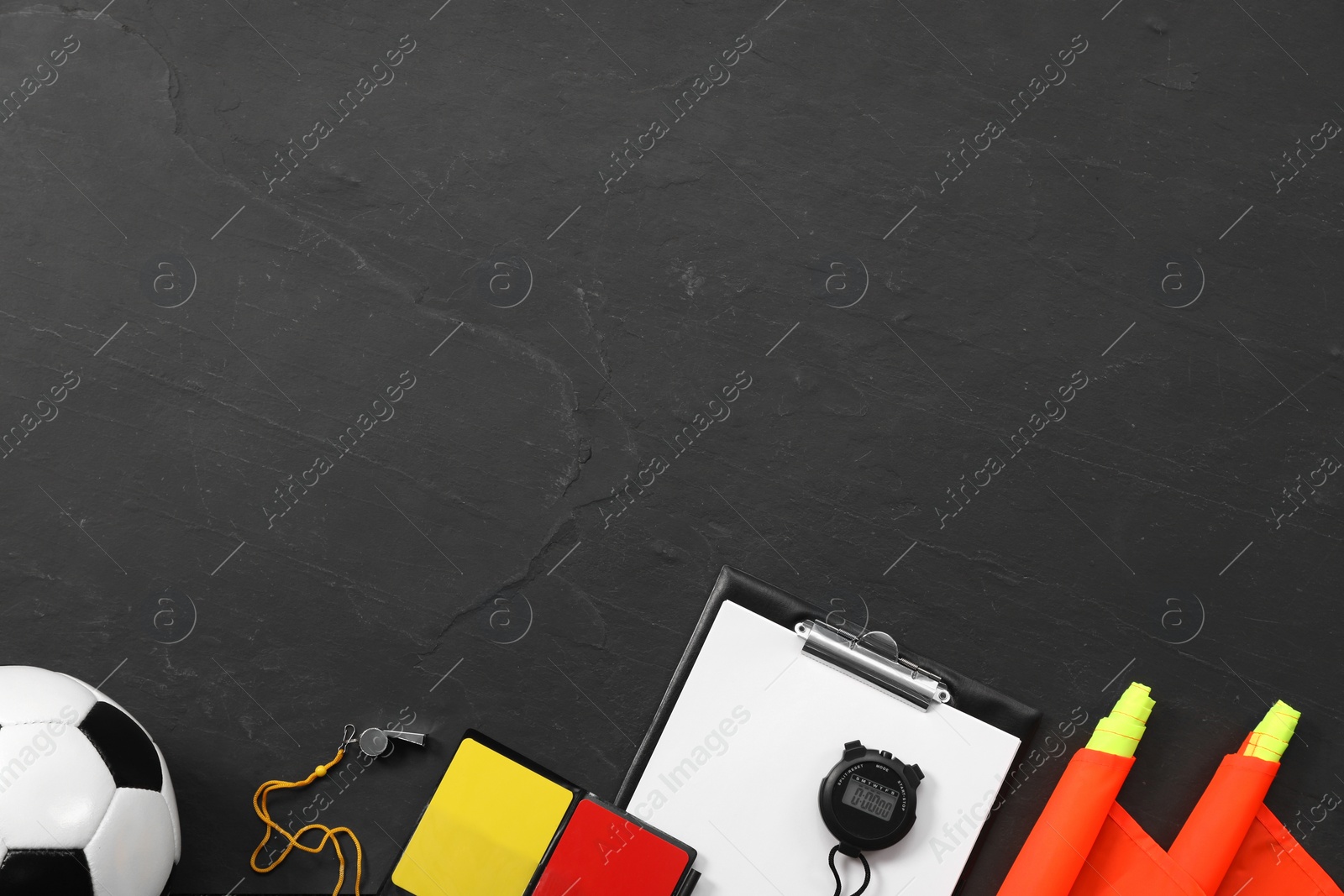 Photo of Different referee equipment on black table, flat lay. Space for text