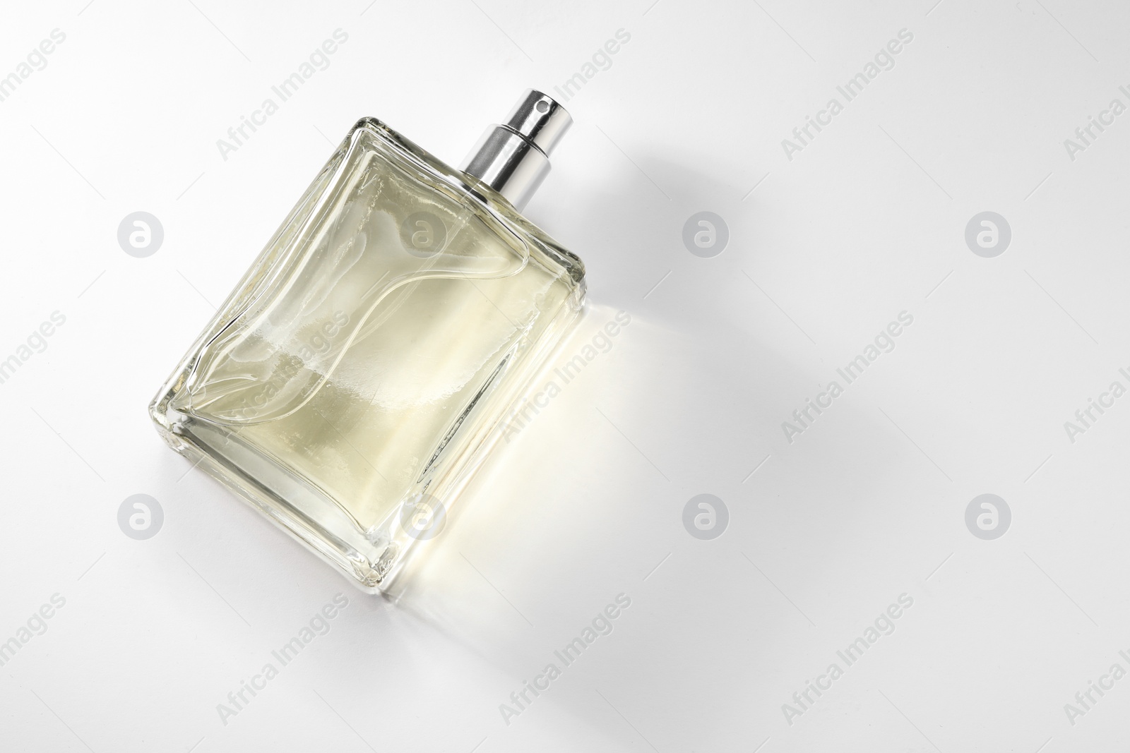 Photo of Luxury men`s perfume in bottle on white background, top view. Space for text