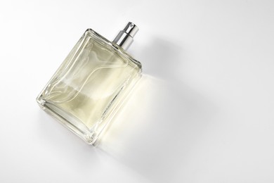 Luxury men`s perfume in bottle on white background, top view. Space for text