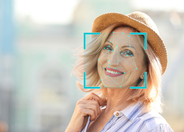 Image of Facial recognition system. Mature woman with scanner frame and digital biometric grid, outdoors