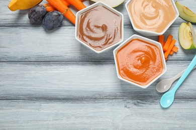 Photo of Healthy baby food and ingredients on grey wooden table, flat lay. Space for text