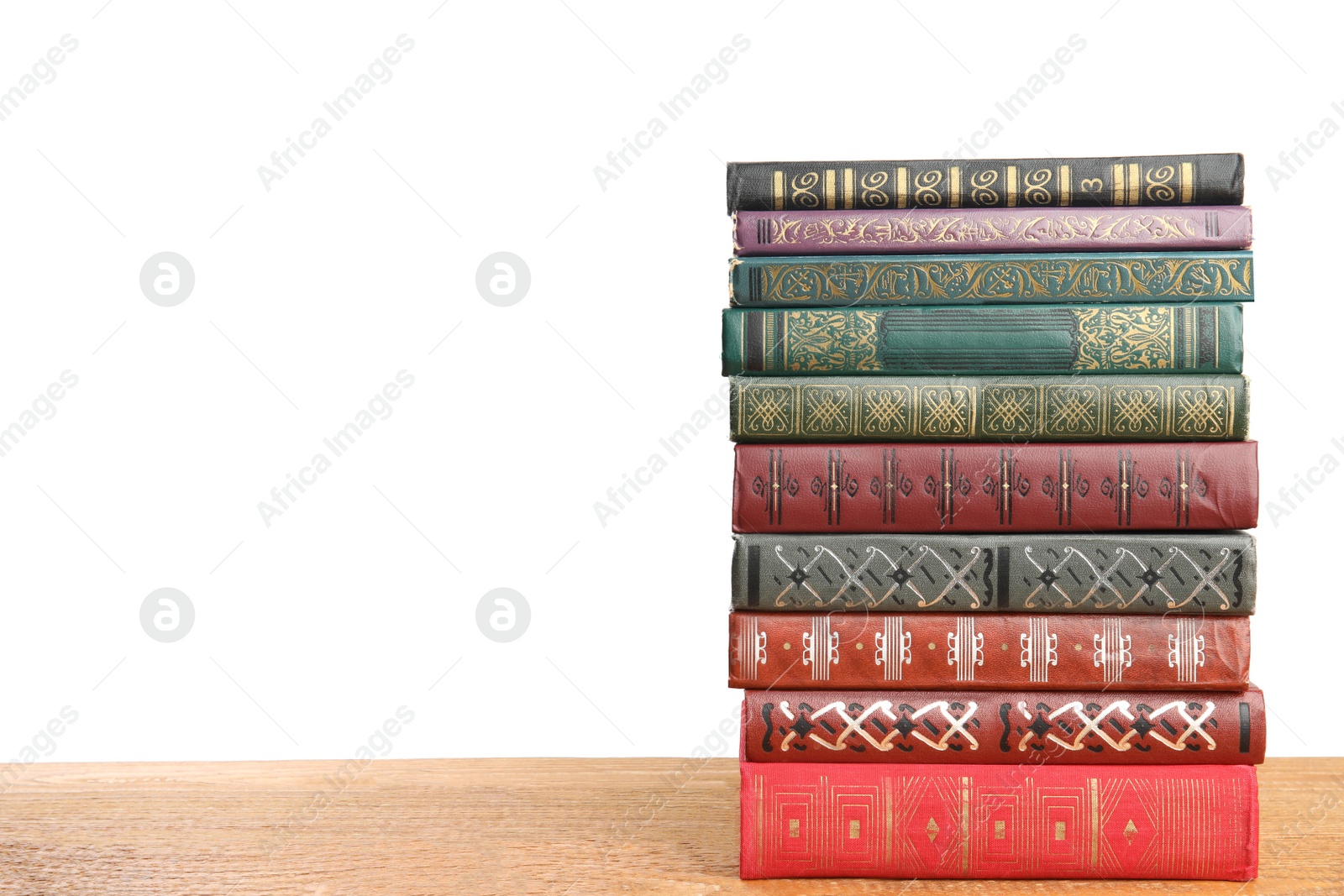 Photo of Stack of old vintage books on wooden table against white background