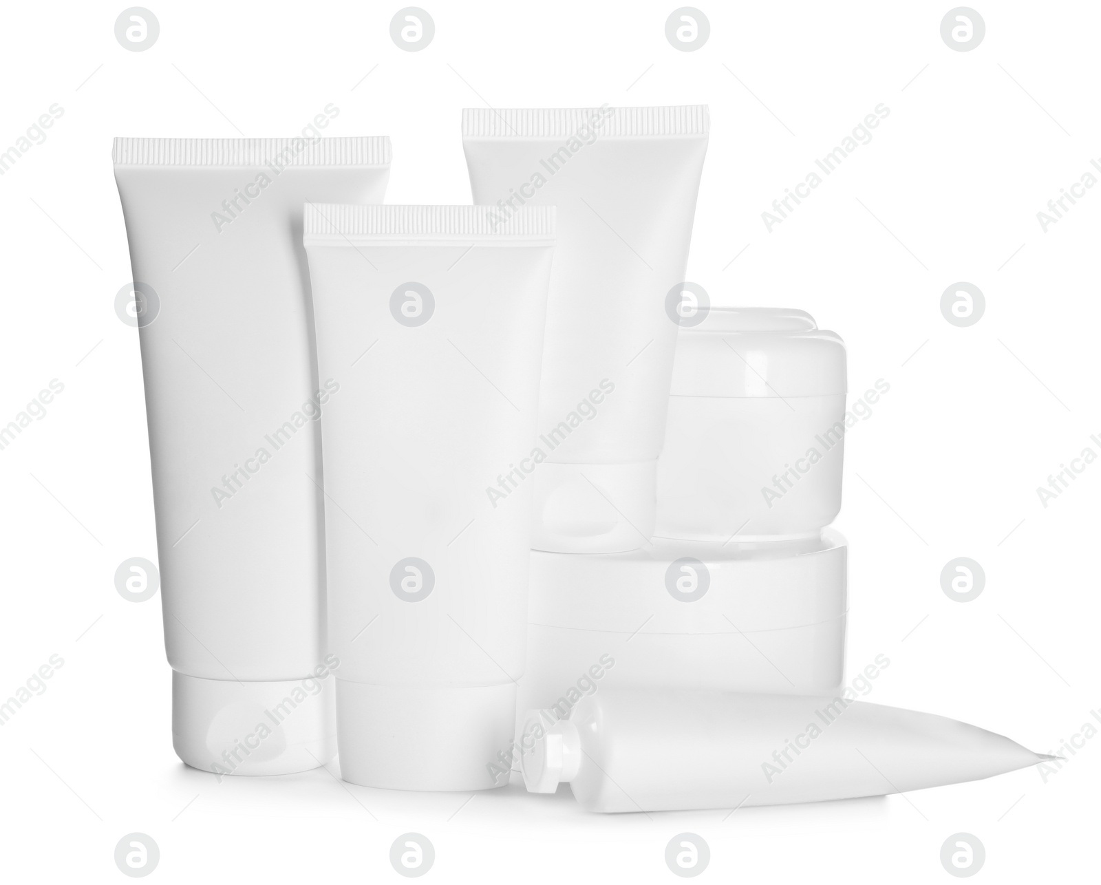 Photo of Blank tubes and jars of cosmetic products on white background