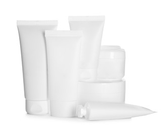 Photo of Blank tubes and jars of cosmetic products on white background