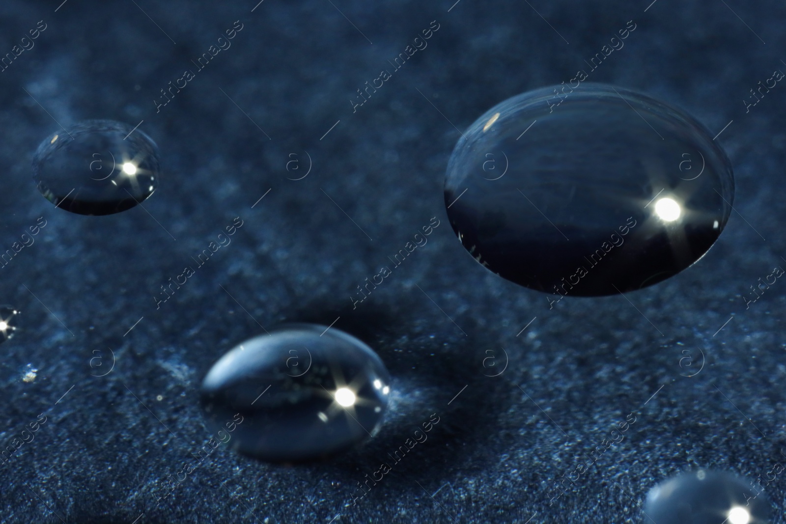 Photo of Water drops on glass against dark gray textured background. Macro photography