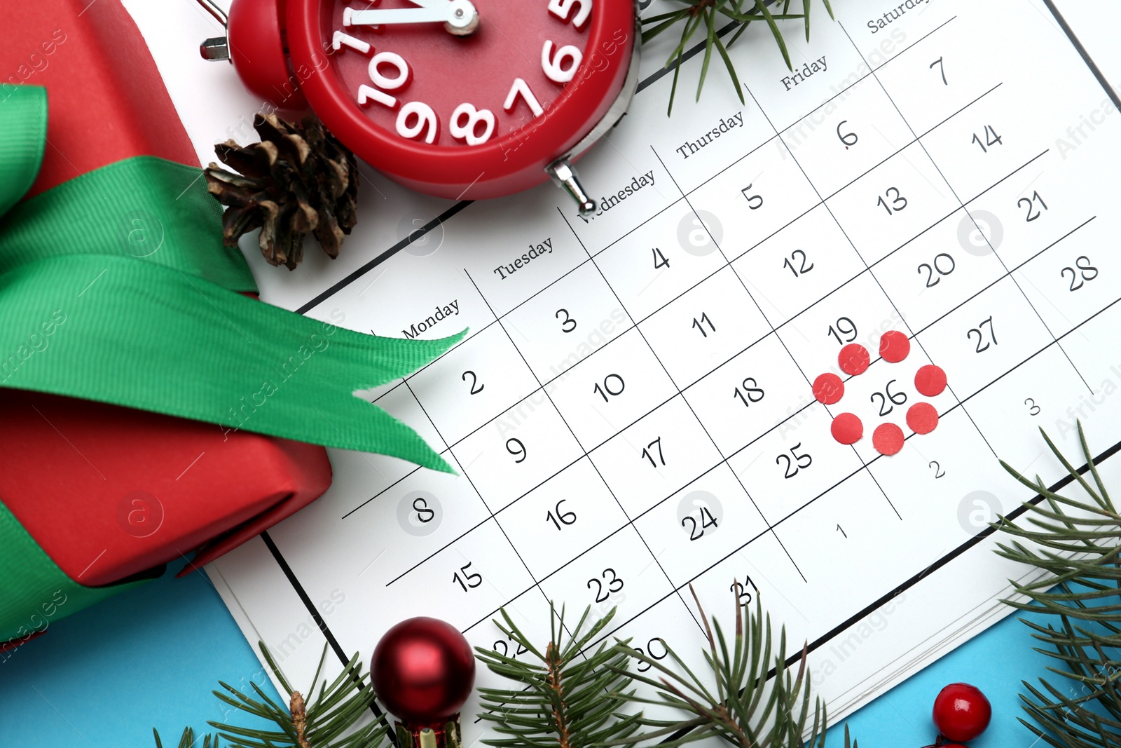 Photo of Flat lay composition with calendar and gift on light blue background. Boxing day concept