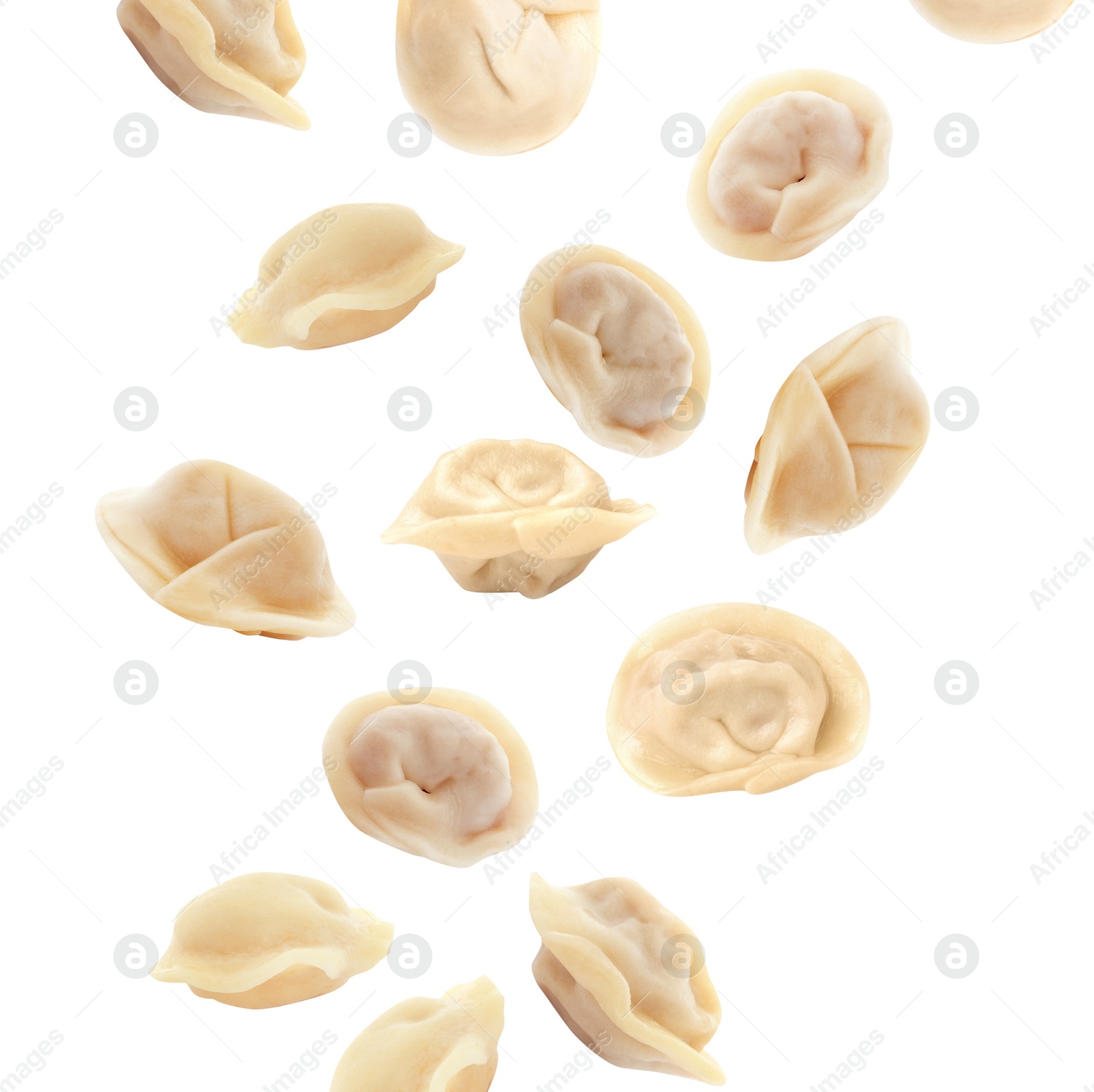 Image of Many tasty dumplings falling on white background