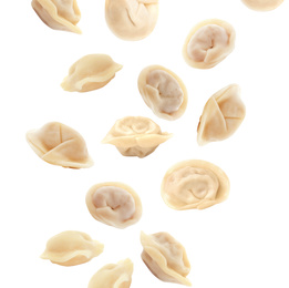 Many tasty dumplings falling on white background