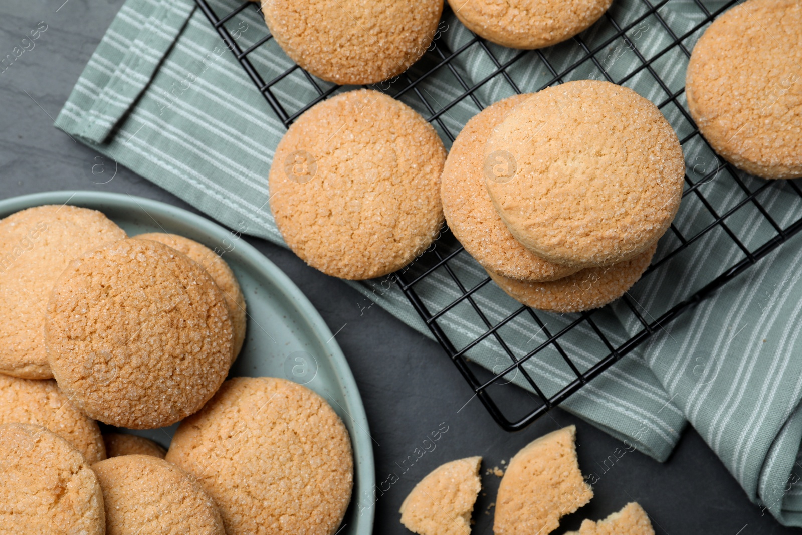 Photo of Delicious sugar cookies on black table, flat lay