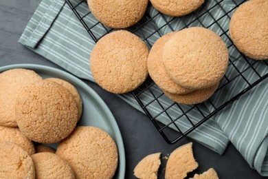 Delicious sugar cookies on black table, flat lay