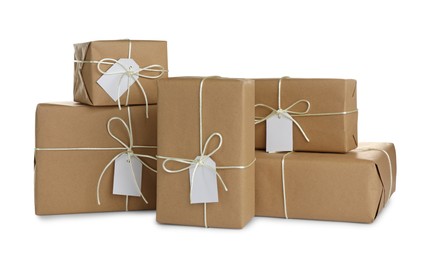 Photo of Parcels wrapped in kraft paper with tags on white background