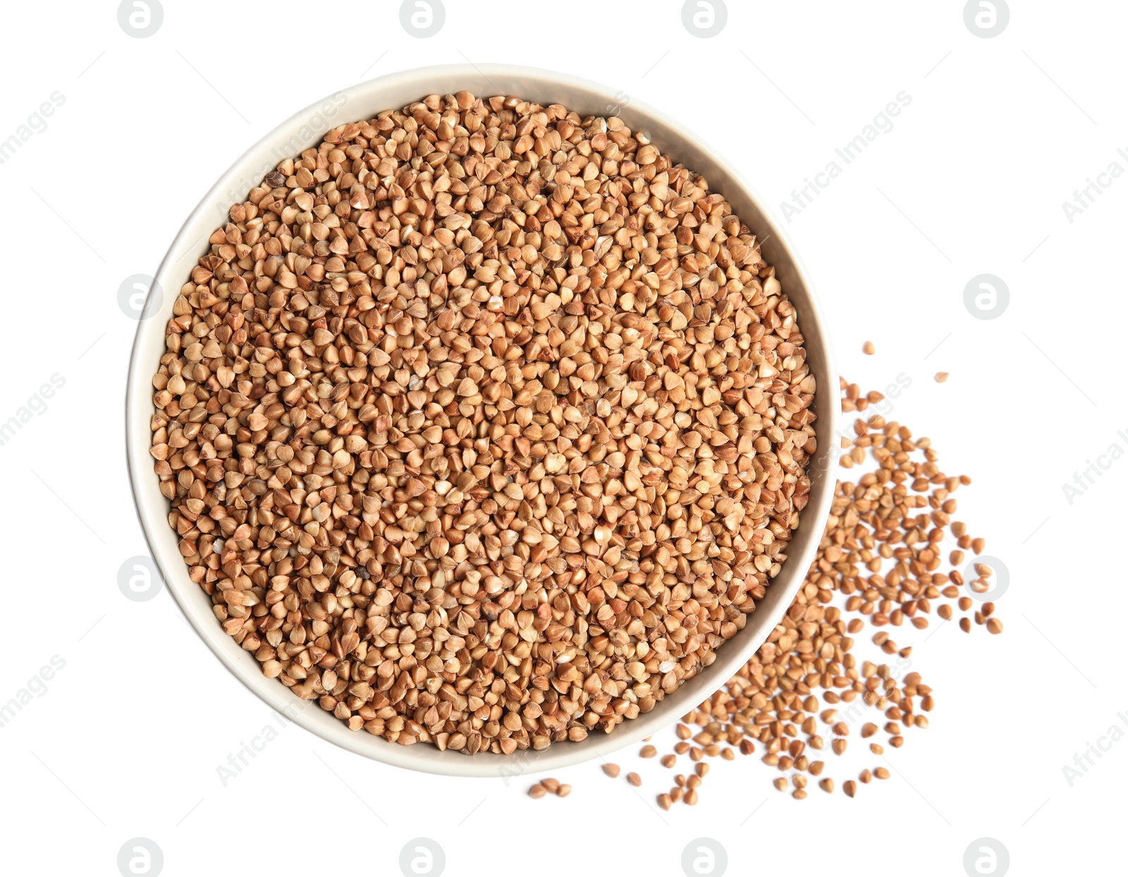 Photo of Bowl with uncooked buckwheat on white background, top view