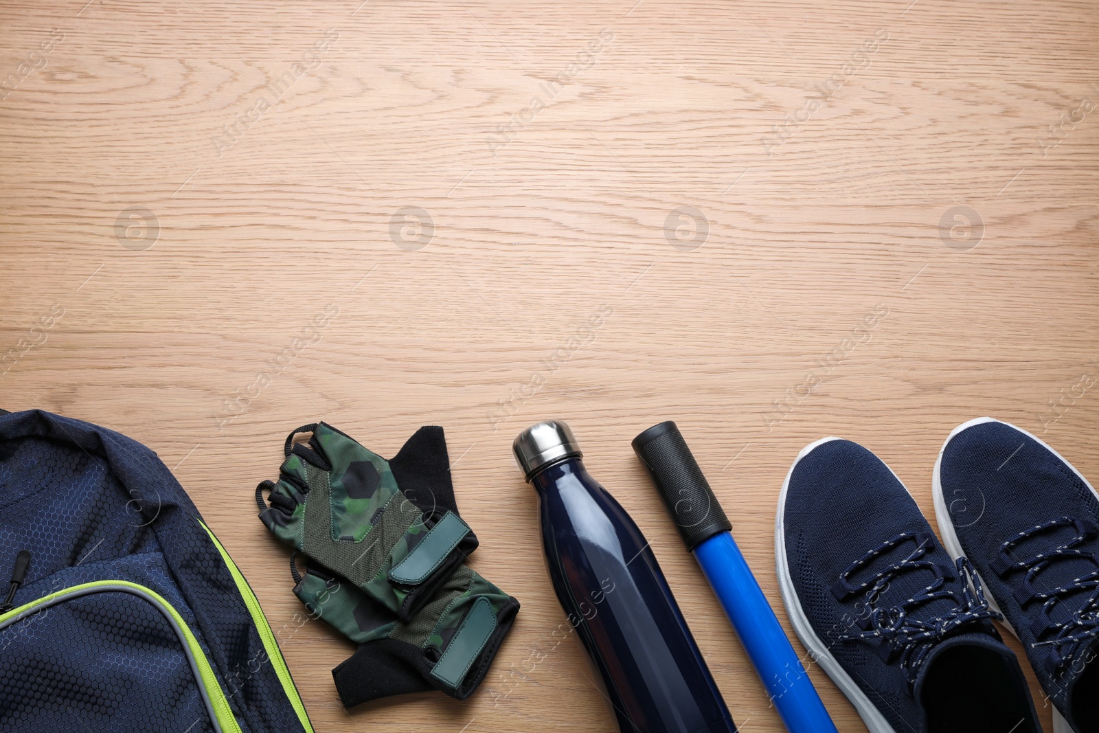 Photo of Flat lay composition with different cycling accessories on wooden background, space for text