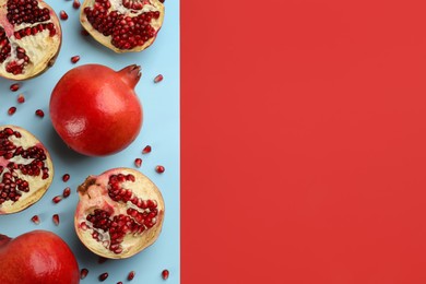 Photo of Flat lay composition with ripe pomegranates on color background. Space for text