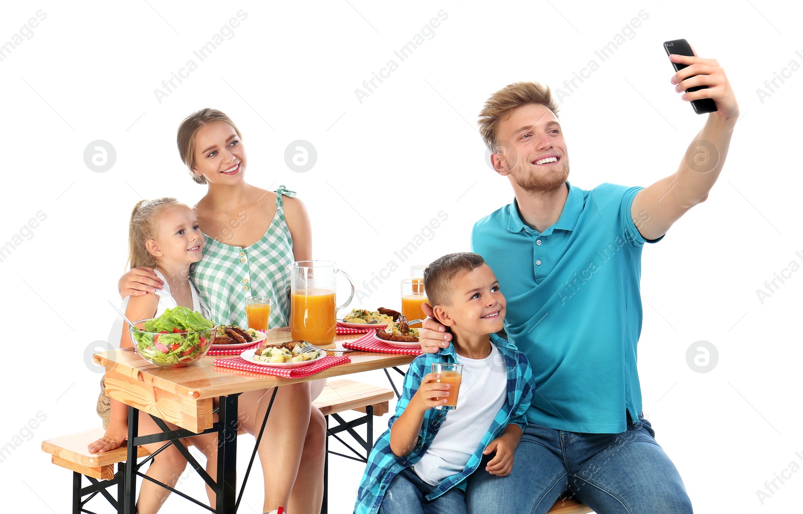 Photo of Happy family taking selfie at picnic table on white background