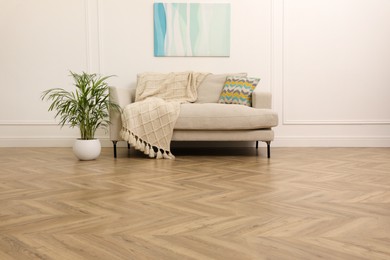 Photo of Modern living room with parquet flooring and stylish sofa